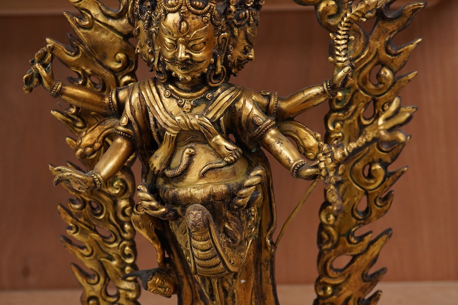 A gilt bronze figure of multi arm Mahakala, 34cm